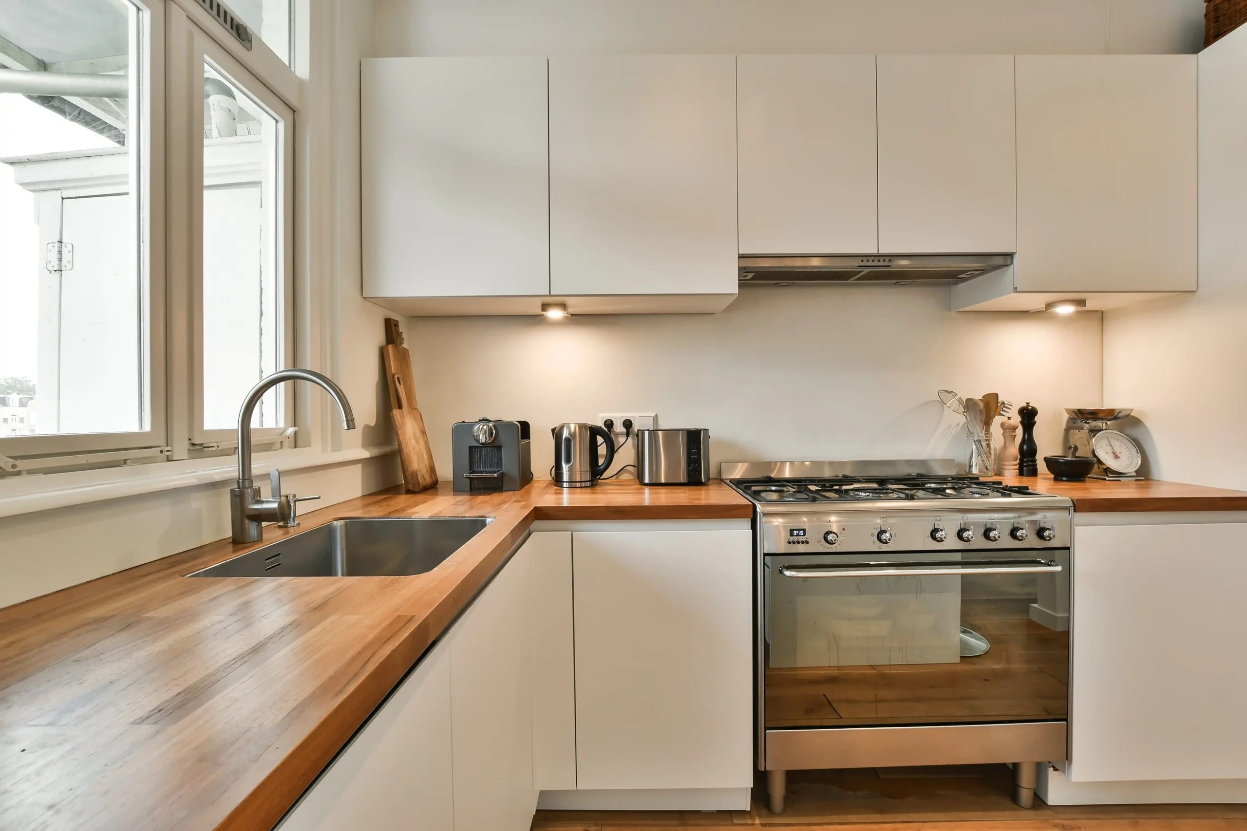 white kitchen cabinets with wood countertops
